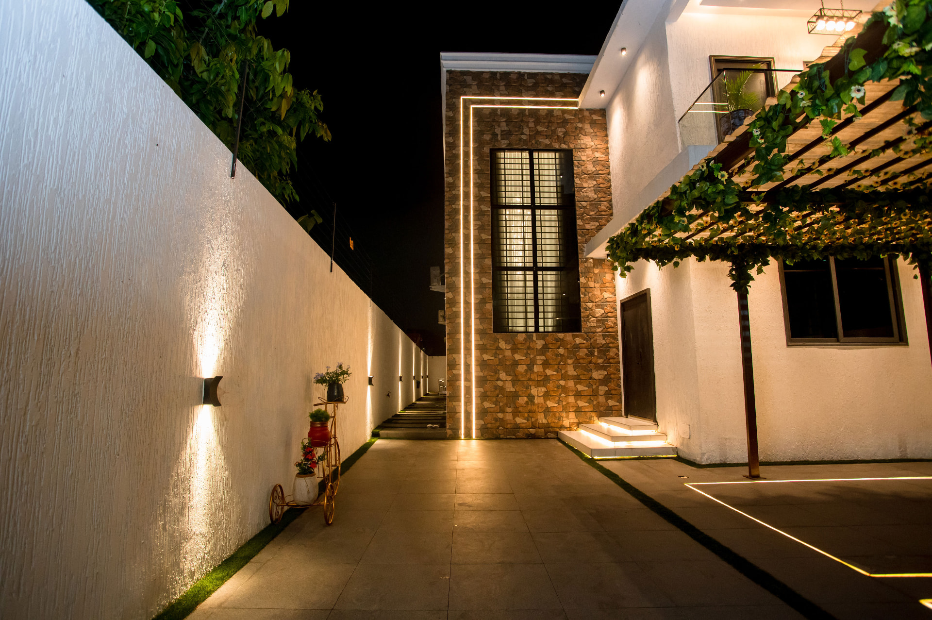 Lit walkway and stone-clad facade at Pryse Enclave, Spintex